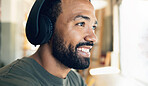 Face, smile and headphones with a gamer man in the living room of his home to play video games closeup. Gaming, esports and a happy young person having fun with online entertainment in his house