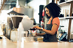 Happy woman, barista and small business owner at cafe for service, coffee or beverage by counter at store. Female person, employee or waiter making espresso, cappuccino or latte at restaurant or shop