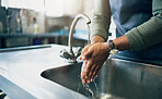 Water, safety and washing hands in the kitchen with a person by the sink for skincare or wellness. Cleaning, hygiene and bacteria with an adult closeup in the home to rinse for skin protection