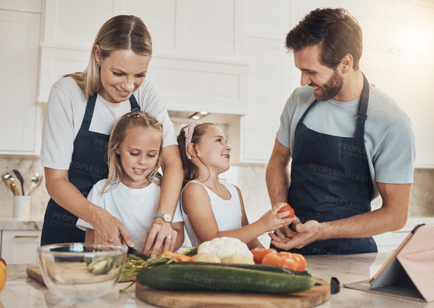 Buy stock photo Love, cooking and family in the kitchen together for bonding and preparing dinner, lunch or supper. Happy, smile and girl children cutting vegetables or ingredients with parents for a meal at home.