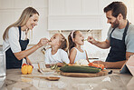 Family, kitchen and vegetables or children feed health food, nutrition, cooking or together. Parents, daughter or smile for dinner or happy eating, salad or vegan recipe or natural diet, meal in home