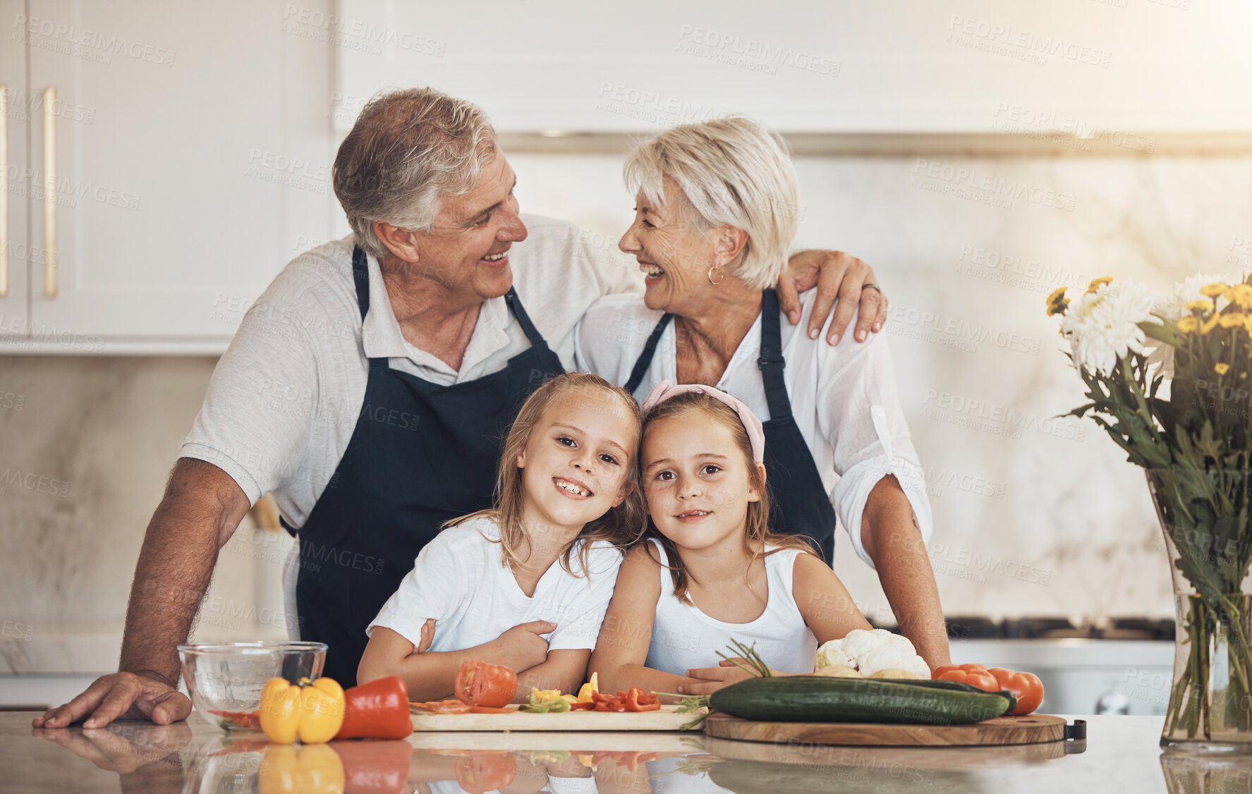 Buy stock photo Happy family, love and grandparents with grandchildren cooking in a kitchen with vegetables. Food, learning and kids with old people at home for nutrition, fun and bond while preparing organic meal 