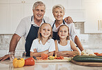 Portrait, family and kids cooking with grandparents in a kitchen with love, care and support at home. Food, face and children learning nutrition, health and preparing meal with happy senior people