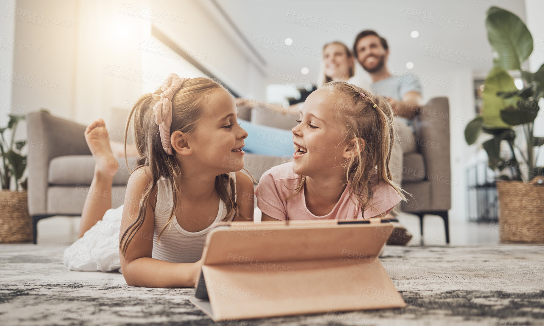 Buy stock photo Kids on floor of living room with tablet, smile and watching video, movie streaming and technology. Digital games, online app and happy girl children relax on carpet together with fun in family home.