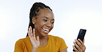 Video call, wave and a black woman with a phone for communication, conversation and a chat. Smile, hello and an African girl greeting while speaking on a mobile and a white background in a studio