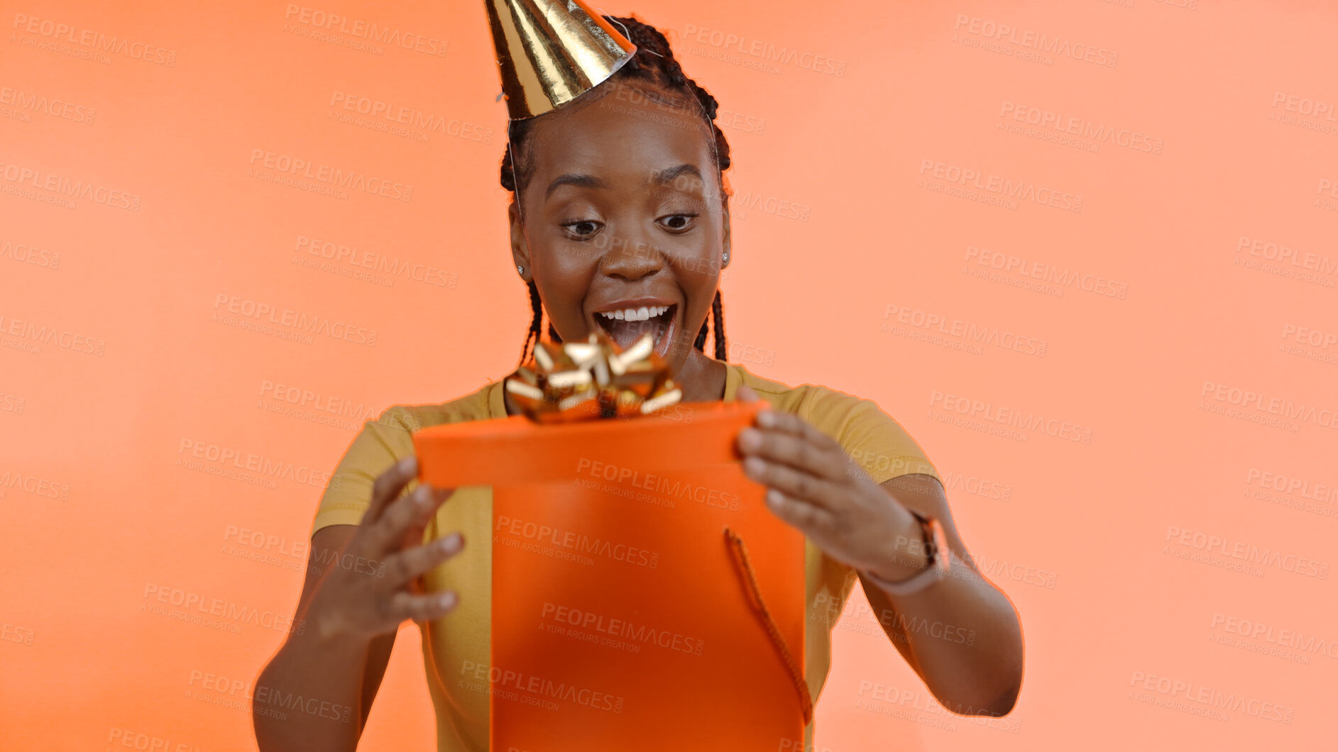 Buy stock photo Birthday, surprise and black woman with present, box or gift on studio peach background or unboxing. Wow, congratulations or excited for giveaway, package or celebration of product on offer at party