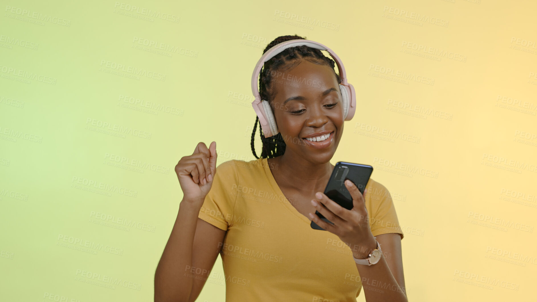 Buy stock photo Face, woman and headphones on phone to dance, stream music and podcast by yellow background. Happy black person, excited and technology and listen to playlist or audio, radio and studio mockup