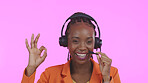 Business woman, call center and okay for communication, happy sales and excellence in customer service on a pink background. Portrait of African consultant in headphones, yes and contact us in studio