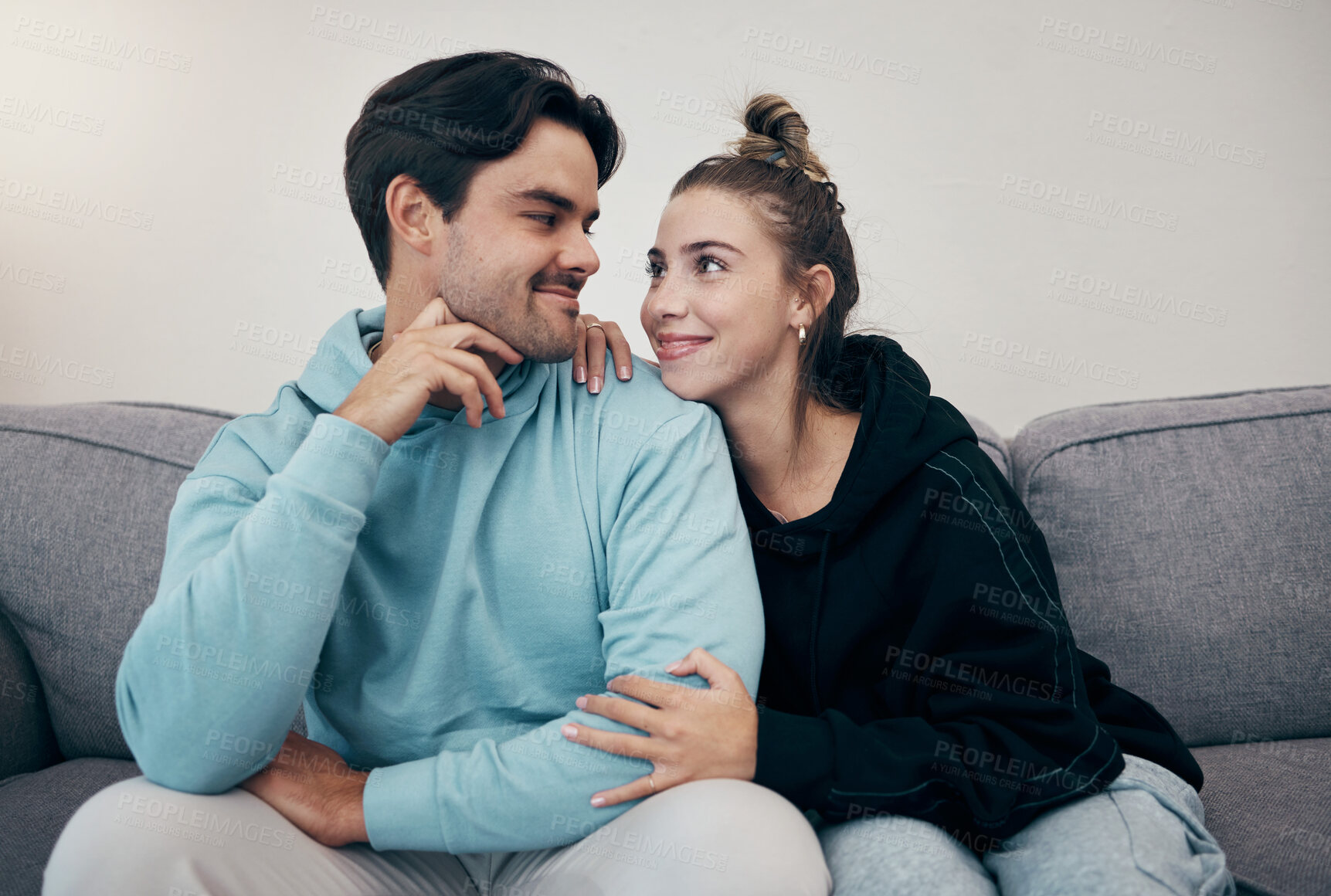 Buy stock photo Smile, bond and couple relax on a sofa with care, hug and support at home together. Love, face and happy young people in a living room connect, chilling and enjoy weekend, relationship or day off