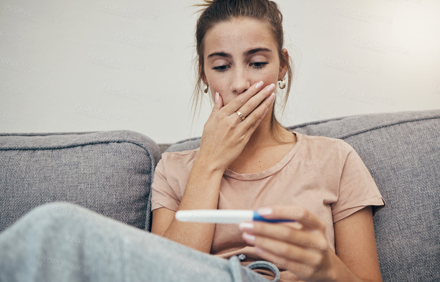 Buy stock photo Pregnancy test, surprise and woman on sofa in home, reading bad news and check negative results. Pregnant, stick and sad mother in living room shocked for maternity, stress and anxiety for fertility