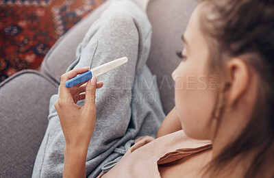 Buy stock photo Pregnancy test, waiting and woman on sofa in home, reading news and check results.,Stick, sad and pregnant mother in living room for future maternity, ivf fertility and anxiety, depressed or serious