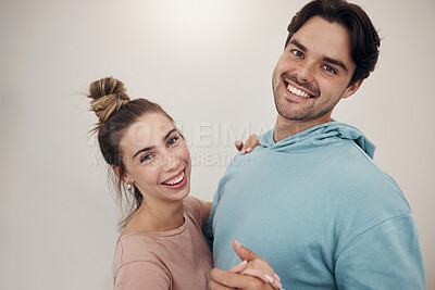 Buy stock photo Portrait, smile and couple dance in a house with music, fun and bonding in their home. Face, hug and happy people dancing to podcast, radio or hifi, laughing and enjoy relationship on wall background