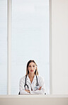 Portrait, doctor and medical with a woman arms crossed in a hospital for healthcare, consulting or trust. Space, serious and a confident young medicine professional at a desk in a cardiology clinic