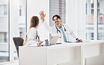 Doctors, healthcare and high five for collaboration with smile at desk for planning, research and medical work in hospital. Medicine, man or woman with teamwork, coworkers or happiness for cardiology