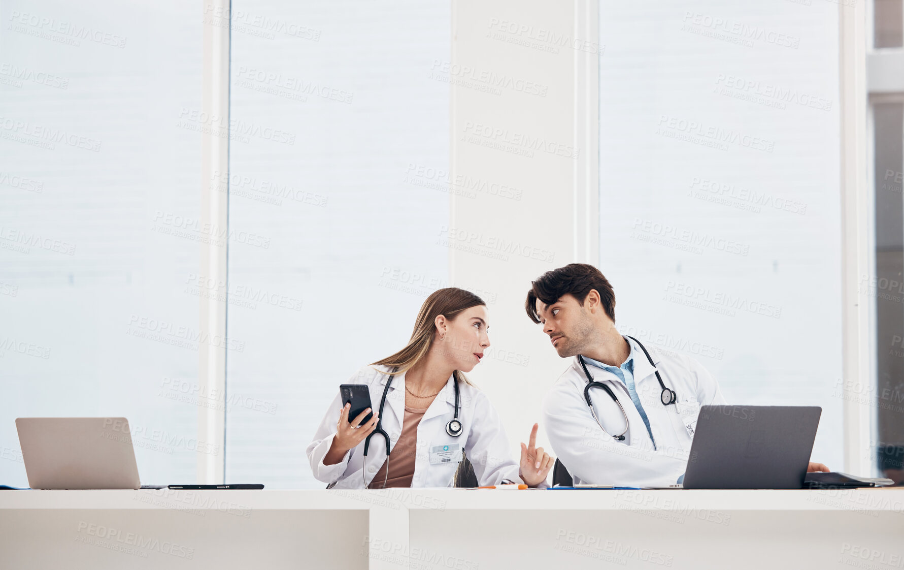 Buy stock photo Doctors, reception desk and colleagues with phone for communication, healthcare planning or research for medical schedule in hospital. Medicine, man and woman with collaboration or working together