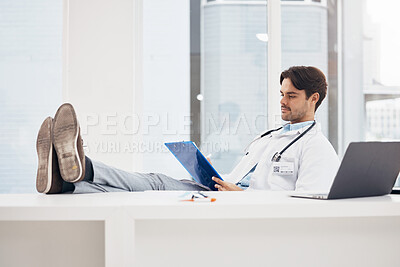 Buy stock photo Doctor, man and relax with feet on desk, reading checklist or thinking on break in hospital office. Medic, document or paperwork for report, results or idea in problem solving, solution or healthcare