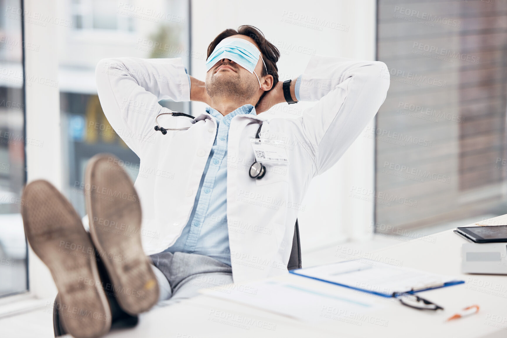 Buy stock photo Man, doctor and sleeping with face mask on break or relax for done, completion or finished at hospital office. Tired male person or medical surgeon chilling for rest or asleep on work desk at clinic