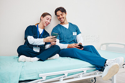 Buy stock photo Doctor, student phone and friends on break with laughing on a hospital, healthcare and clinic bed with social media. Smile, mobile and happy young people with rest from medical and nursing internship