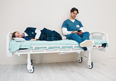 Buy stock photo Tired doctors, sleeping woman and man with phone, texting and relax on break at hospital job. Medic team, partnership or friends with burnout, smartphone and fatigue with healthcare, clinic and rest