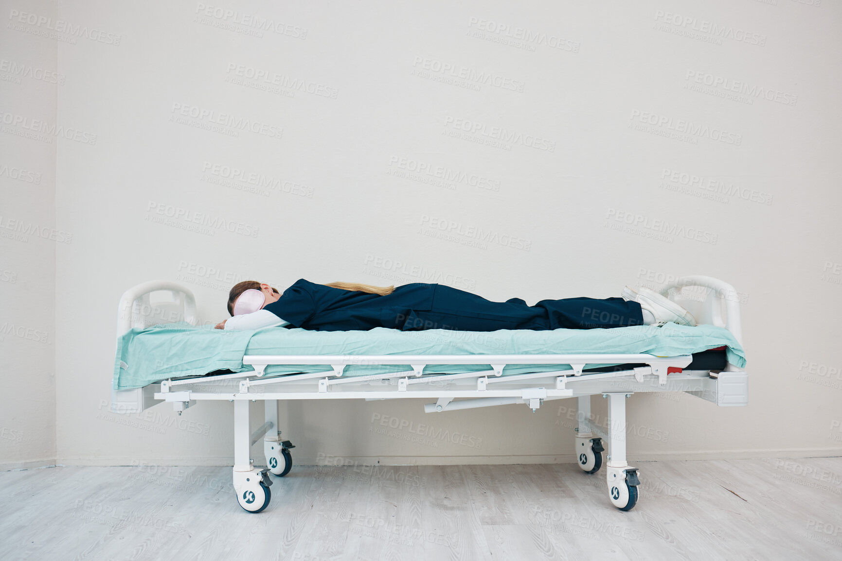 Buy stock photo Doctor, sleeping and break on hospital bed, tired and burnout from healthcare service, overworked and exhausted. Nurse, woman and rest with fatigue, shift and stress for nap, relaxing and employee