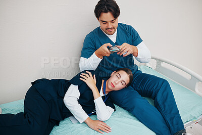 Buy stock photo Doctors, friends and sleeping in picture for social median phone in clinic, joke and silly or goofy. Medical professionals, fun and comedy on break, tired and fatigue from work, hospital bed and rest