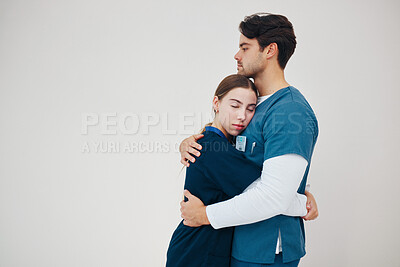 Buy stock photo Doctor, colleagues and tired stress for support, healthcare clinic or hug. Medical professionals, friends and helping comfort in scrubs on wall background, mockup space or fatigue trust at hospital