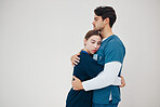 Doctor, colleagues and tired fatigue or support at healthcare clinic, work stress or hug. Medical professionals, friends or helping comfort in scrubs on wall background, mockup or burnout at hospital