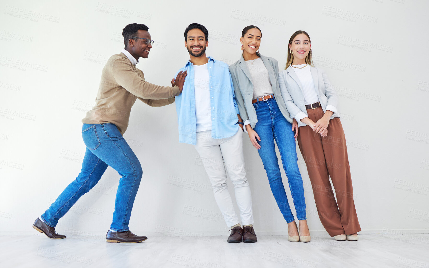 Buy stock photo Black man pushing team of business people, portrait and smile in office together for synergy. Strong professional support group of employees, solidarity for collaboration and cooperation in startup