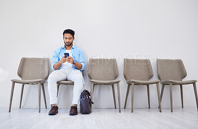 Buy stock photo Waiting room, hiring and man on a phone in office for interview in job search for appointment. Recruit, career and male person networking on cellphone for meeting with human resources in workplace.