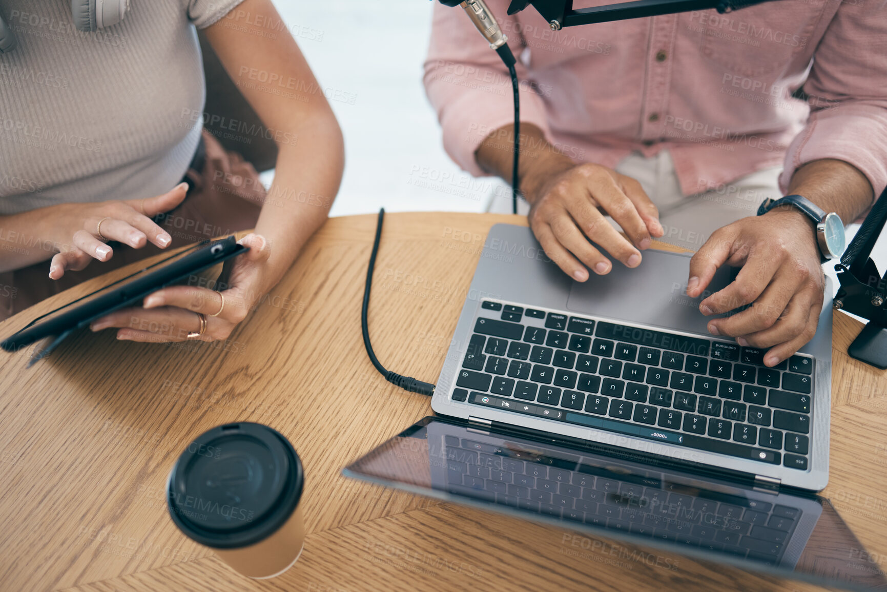 Buy stock photo Radio presenter, communication and technology in studio for media company, talking on laptop and tablet. Web, people  or influencer on microphone in live stream of music, podcast and talk show speaker