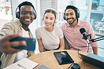 Podcast, happy and group selfie of friends together, live streaming or people recording broadcast in studio. Team of radio hosts take photo at table for social media blog on headphones or microphone