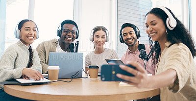 Buy stock photo Podcast, smile and group selfie of friends together bonding, live streaming and people recording broadcast in studio. Happy team of radio hosts take picture at table for social media or collaboration