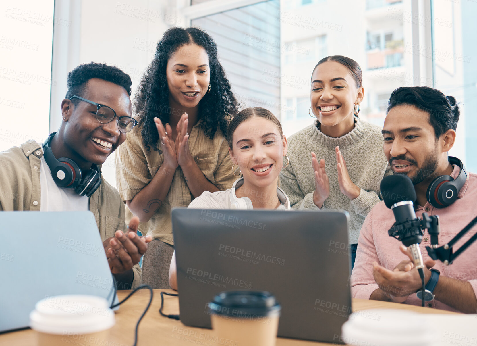 Buy stock photo Radio group, applause and team with celebration, laptop and live streaming with prize, award and cooperation. People, presenter and staff with achievement, clapping and success with a pc and podcast