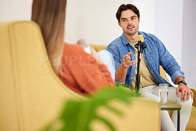 Buy stock photo Man, woman and microphone for podcast, interview or question in conversation, speaking and lounge chair. Talk show, mic and people for web radio broadcast, live streaming and happy on social network