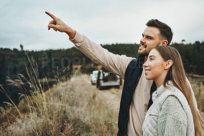 Buy stock photo Couple, hiking and pointing on mountain for road trip, vacation or outdoor adventure together in nature. Happy man and woman smile for trekking, holiday vacation or travel on journey or showing path