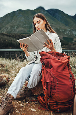 Buy stock photo Tablet, reading and woman hiking with backpack in nature on mountain for adventure and weekend trip. Digital technology, bag and female person from Canada checking information and trekking in forest.
