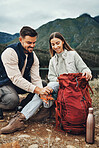 Couple, hiking and packing backpack in nature with smile, check and thinking by hill, mountains and outdoor. Man, woman and luggage for trekking, happy and ideas on fitness adventure in countryside