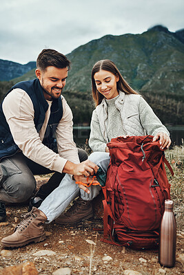 Buy stock photo Couple, hiking and packing backpack in nature with smile, check and thinking by hill, mountains and outdoor. Man, woman and luggage for trekking, happy and ideas on fitness adventure in countryside