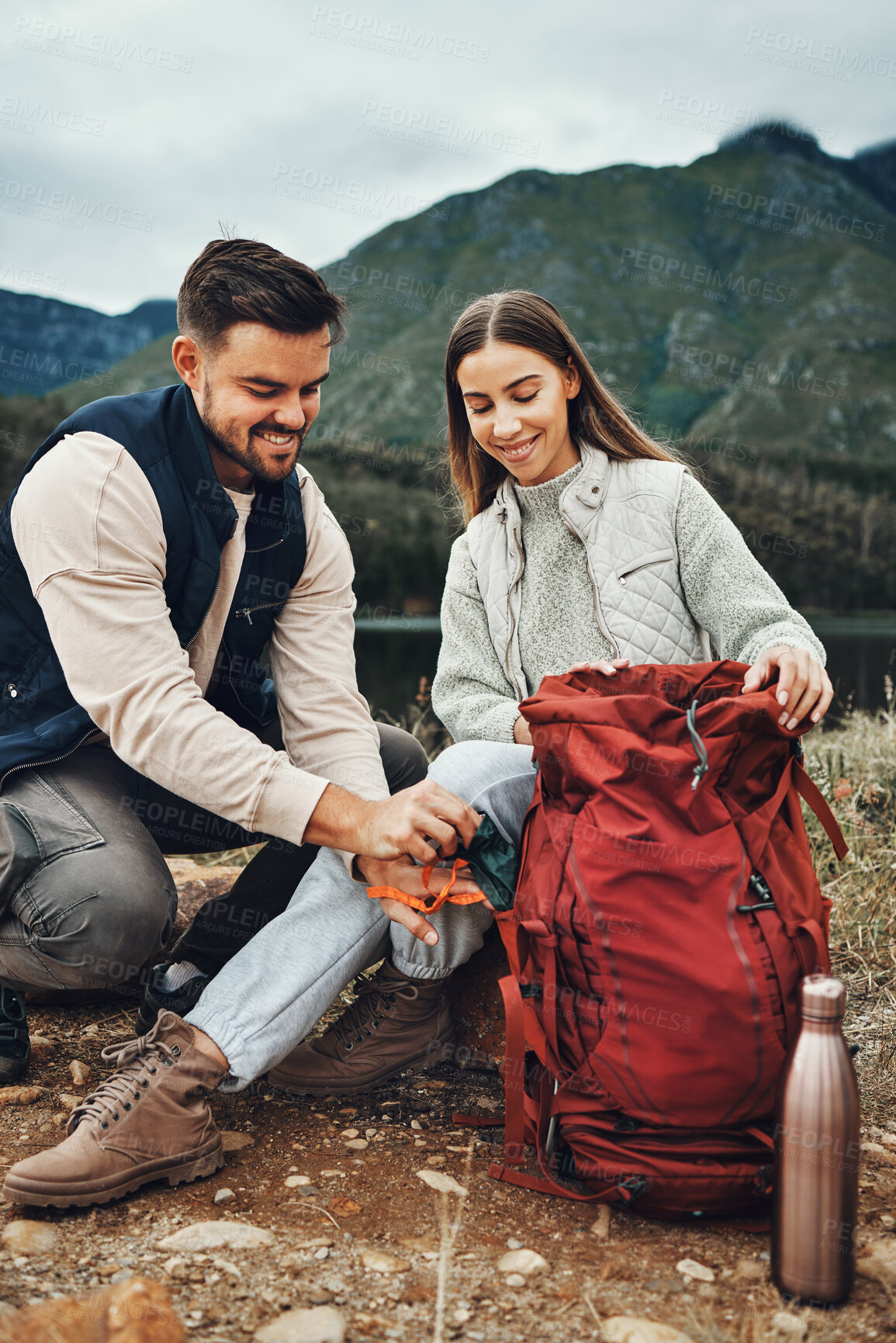 Buy stock photo Couple, hiking and packing backpack in nature with smile, check and thinking by hill, mountains and outdoor. Man, woman and luggage for trekking, happy and ideas on fitness adventure in countryside