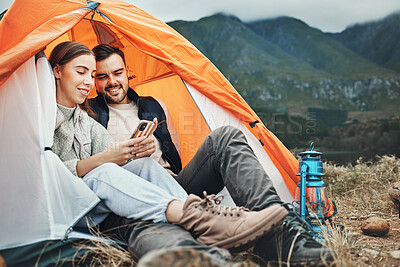 Buy stock photo Couple, tent and camping with phone, smile and reading for holiday, web blog and morning in countryside. Man, woman and relax with vacation, social media and adventure with love, outdoor and freedom