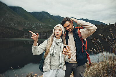 Buy stock photo Hiking, stress and lost couple with a phone in nature for direction, map or navigation with anxiety. Backpacking, travel and people with smartphone app for location search or navigation to campsite
