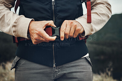 Buy stock photo Closeup hands, man and nature fastening a backpack for hiking, trekking or travel in the mountains. Walking, buckle clip and a tourist with a bag in the woods for activity, fitness and exercise