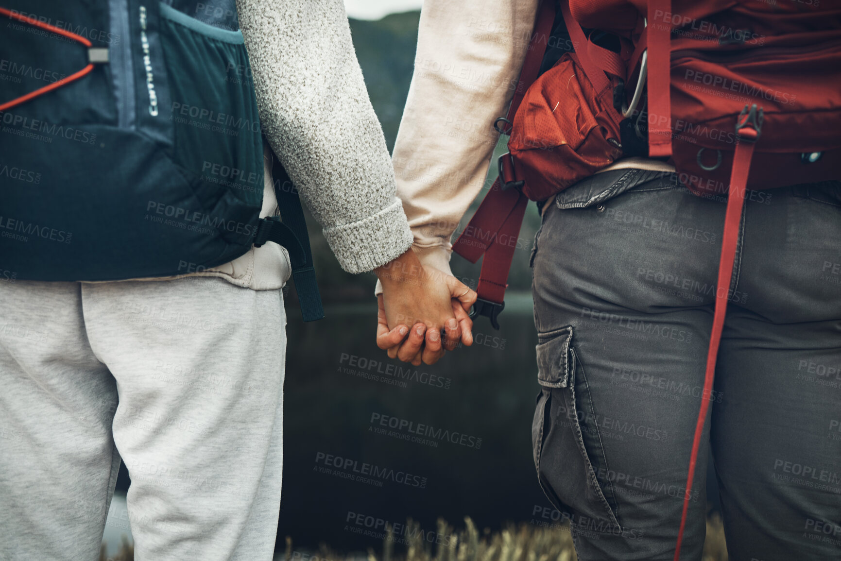 Buy stock photo Couple, holding hands and backpack in nature for hiking, adventure or outdoor journey together. Rear view or closeup of hiker, people or backpacking in teamwork for trekking, motivation or support