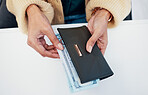 Person, hands and wallet with money for savings, investment or payment on counter at checkout. Top view or closeup of employee with cash, bills or paper notes for finance, purchase or shopping