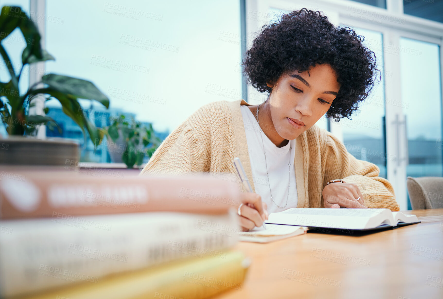 Buy stock photo Bible, religion and woman with study of theology in home, Christian faith and knowledge of God for hope. Reading, spiritual writing and girl at desk with holy books, learning gospel story and prayer.