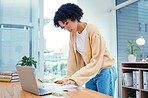 Woman with laptop, documents and standing in office with admin, internet and creative ideas for freelance project. Remote work, reading paperwork and girl with computer, research and notes for agenda