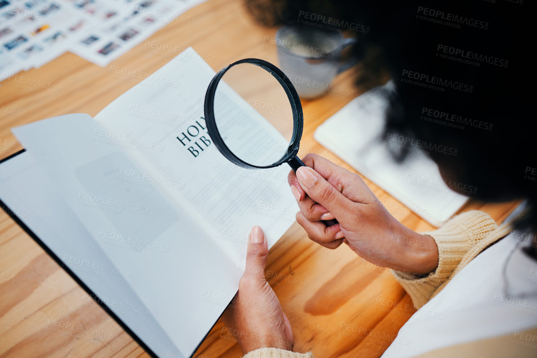 Buy stock photo Bible, research and person with magnifying glass to study religion, holy spirit and the gospel of God to worship. Information, spiritual and closeup of Christian learning faith, hope and prayer