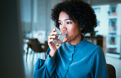 Buy stock photo Woman, drinking water and night in office, reading or thinking for hydration, wellness or finance company. Accountant, glass and computer for nutrition, diet or detox for health, idea or workplace