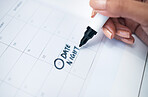 Person, hand and marker on calendar for date, schedule planning or agender on paper on office desk. Closeup of woman writing daily plan, anniversary or tasks for reminder or memory at workplace