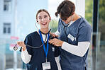 Couple, happy and doctors with stethoscope for love, relationship and work romance in clinic. Healthcare team, hospital and playful man and woman in medical service, support and medicare career
